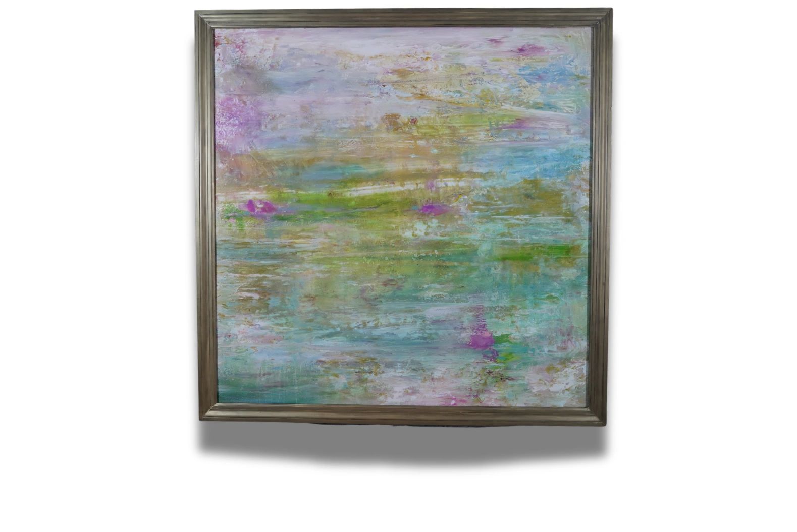 Abstract painting with pastel colors in a simple wooden frame.
