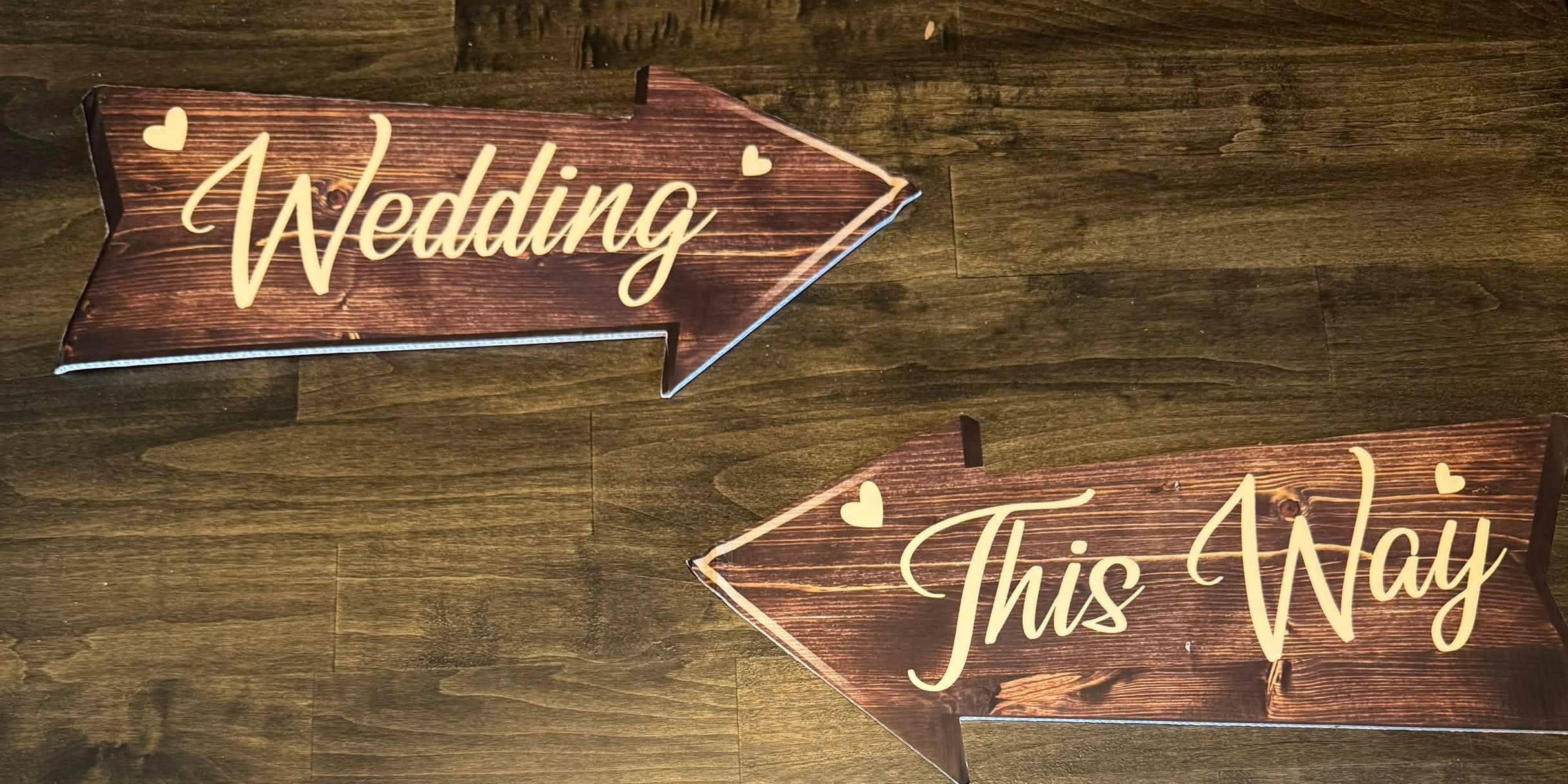 Wooden arrows pointing the way to a wedding celebration.