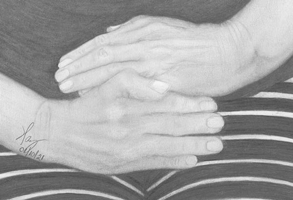 Two hands folded on the body