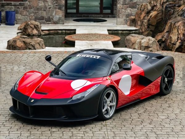 Red and black Ferrari LaFerrari with racing decals.