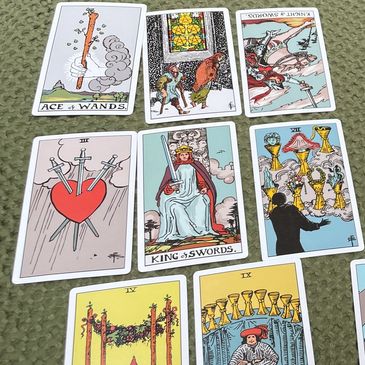 Spread of tarot cards on a textured surface.