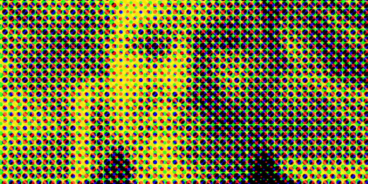Close-up of colorful halftone dots in red, green, blue, and yellow.