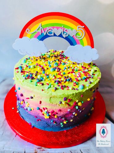 Bright rainbow cake with multi coloured sprinkles