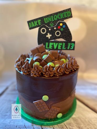 Chocolate ganache covered cake with sweets and chocolate decorations 