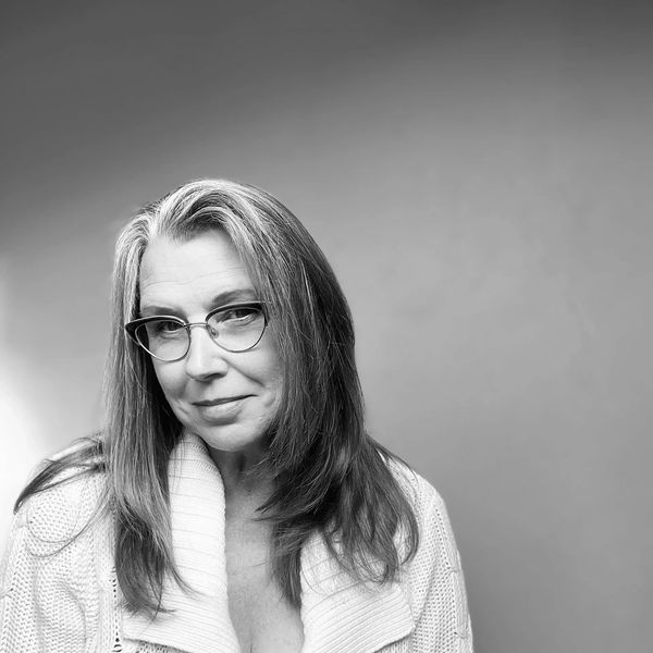 Black and white portrait of a woman with glasses and a cozy knit sweater,Karen Bender, artist