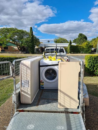 Trailer with donated white goods and furniture.