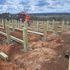 Setting the concrete pier post and beam foundation for a ranch style house