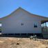 Side view of this Ranch style house covered with 8" Hardie plank lap siding.