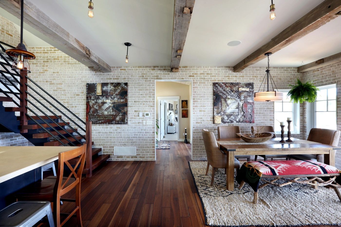 Custom dining area with exposed brick and reclaimed beams, built by True North Building Group