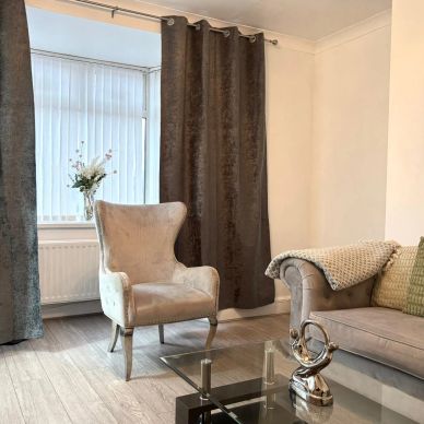 Modern living room with neutral tones and elegant furniture.