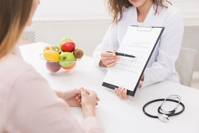 Coach and client reviewing holistic weight loss plan with Ozempic® support tools visible