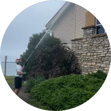 A pressure washing technician performs the soft wash process to gently clean the siding. 