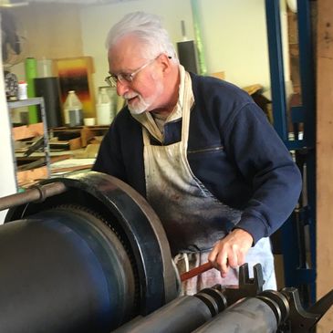 Printmaking Artist Jack Pachuta creates art on the press at the Ozaukee Art Center.