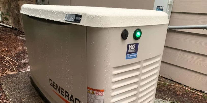 Outdoor Generac generator installed beside a house with rain droplets on it.