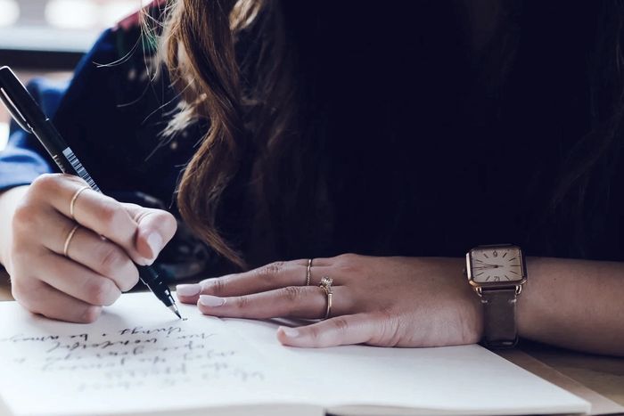 Image of person writing in cursive