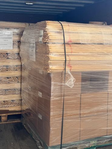 Wooden dowels and boxes wrapped on a pallet, ready for shipment.