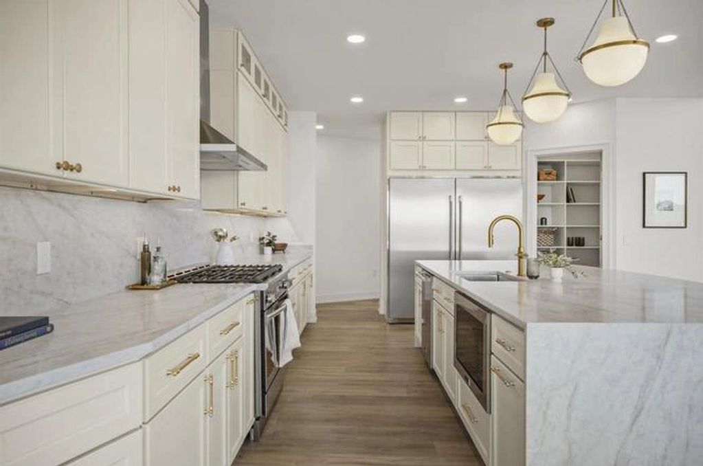 Kitchen showcases Taj Mahal quartz countertops 