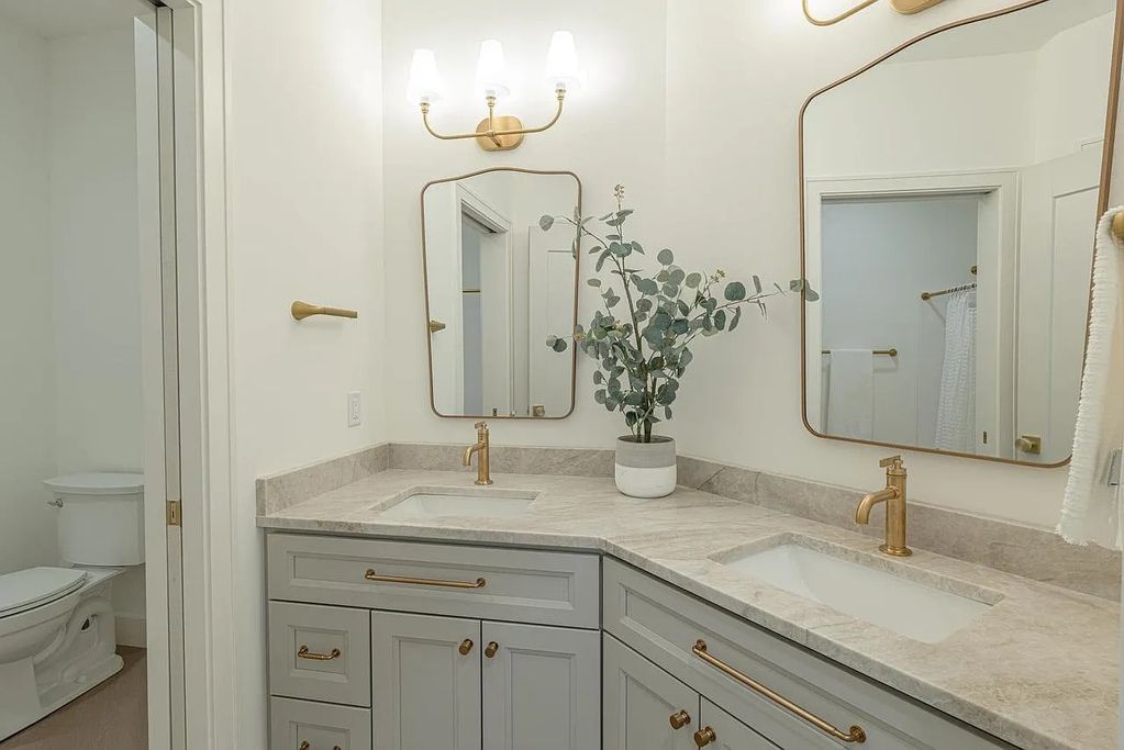 Taj Mahal Quartzite for the kitchen countertops with full height backsplash and a double vanity by D
