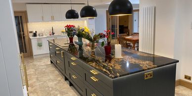 Coombe Hill rear extension, new kitchen with dark island and stone-effect floor