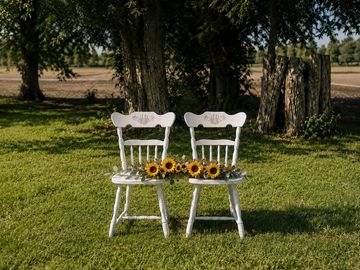 Two white rustic head table chairs