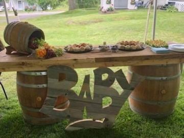 Rustic wooden 7ft display top with 2 wine barrels and wooden baby sign  Great for baby shower