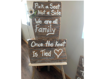 Rustic wooden Pick a Seat not a side sign on a wooden easel