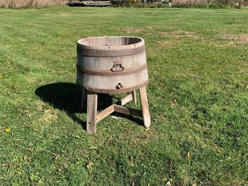 half  wooden whiskey barrel on legs.  This is great for drinks for your event