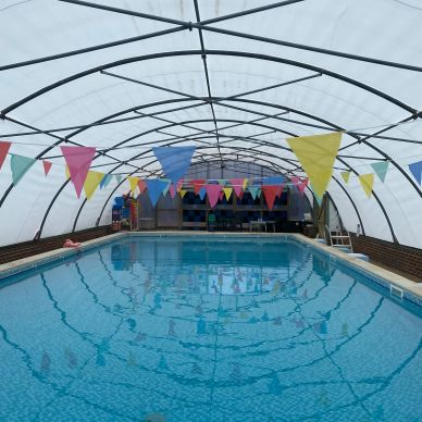 Indoor pool with colorful flags.