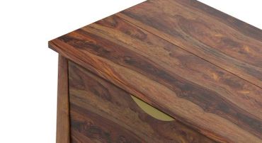 Close-up of a wooden furniture corner with a drawer.