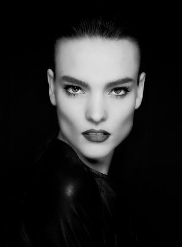 Black and white portrait of a woman with intense gaze.