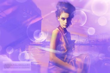 Woman in purple dress surrounded by dreamy, purple light effects.