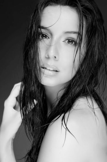 Black and white portrait of a woman with wet hair.