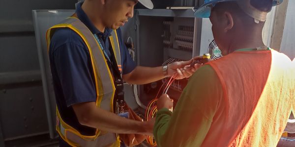 Electrical Engineer instructing technician