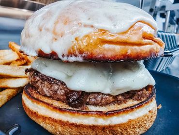Juicy cheeseburger with melted cheese and crispy fries on the side.