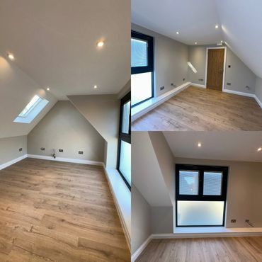 Empty modern attic room with wooden flooring and slanted ceilings.