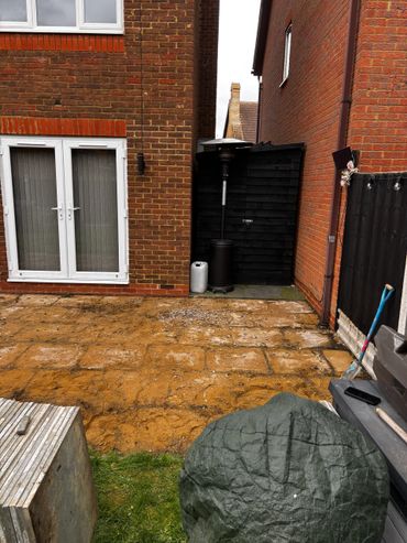 existing patio slabs have been taken up revealing the sand base underneath. 