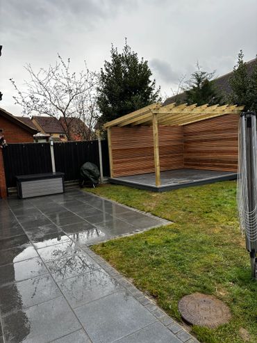 new bespoke pergola with cedar slats, composite decking and new laid patio slabs. 