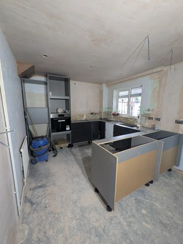 partition wall removed, howdens base units in, ceiling and walls bonded and plastered. 