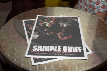 Magazine titled 'Sample Chief' on a round metal table.