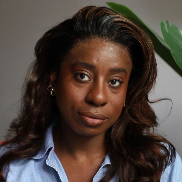 Portrait of a woman with long hair and hoop earrings.