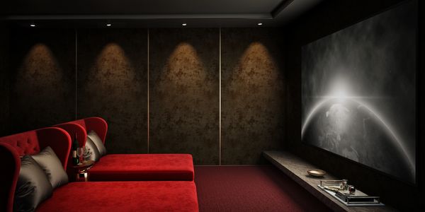 a home theatre with red chairs and a modern screen.