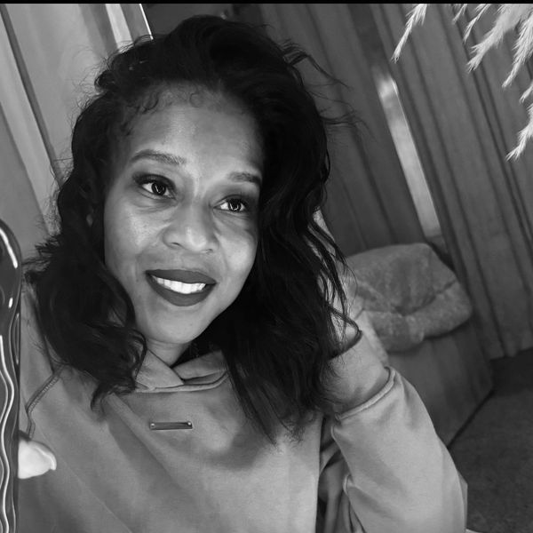 Smiling woman taking a selfie indoors.