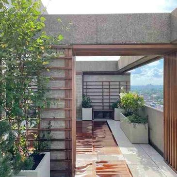 A Japanese garden-inspired condo terrace with custom-made trellises that match the wood decking.