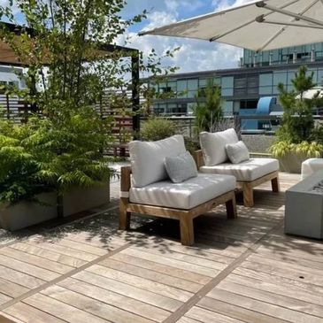 A penthouse terrace with a pergola surrounded by custom-made planter boxes by Box Design Inc.