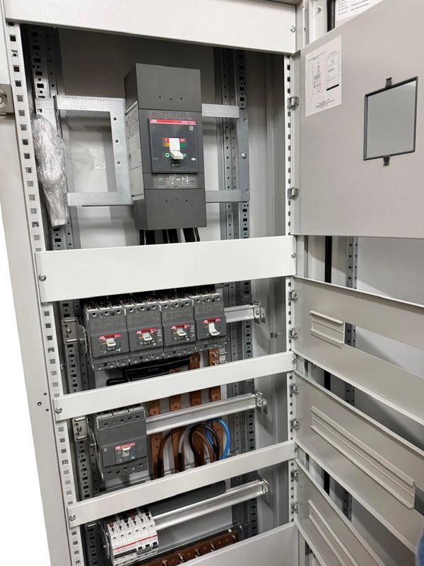 Open electrical panel with circuit breakers and wiring inside.