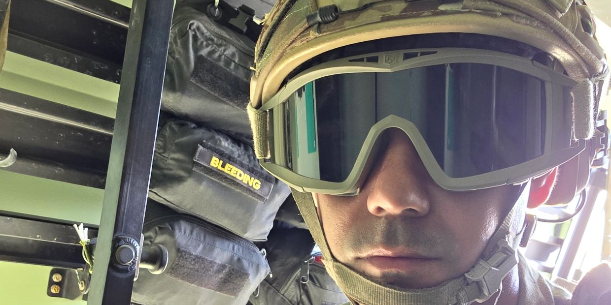 Close-up of a soldier wearing a helmet and reflective goggles.