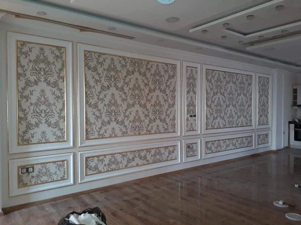 Elegant wall panels with intricate floral patterns in a spacious room.