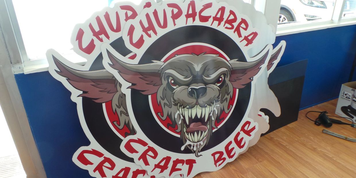 Sign featuring a snarling chupacabra for craft beer.