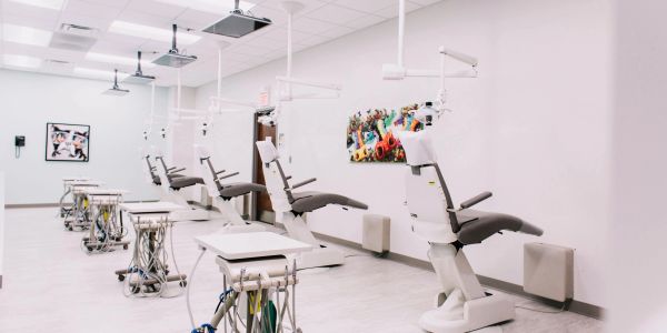Modern dental clinic with multiple dental chairs and equipment.