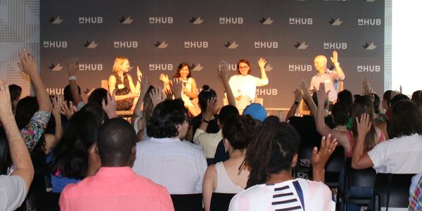 From Chicago Climate Connect's July event: 4 smiling panelists and an audience with raised hands